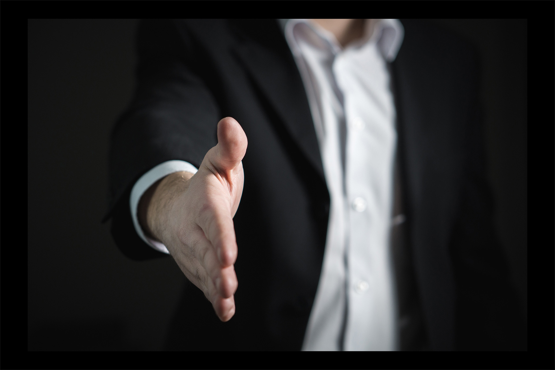 This is an image of an open hand awaiting a handshake from another person.