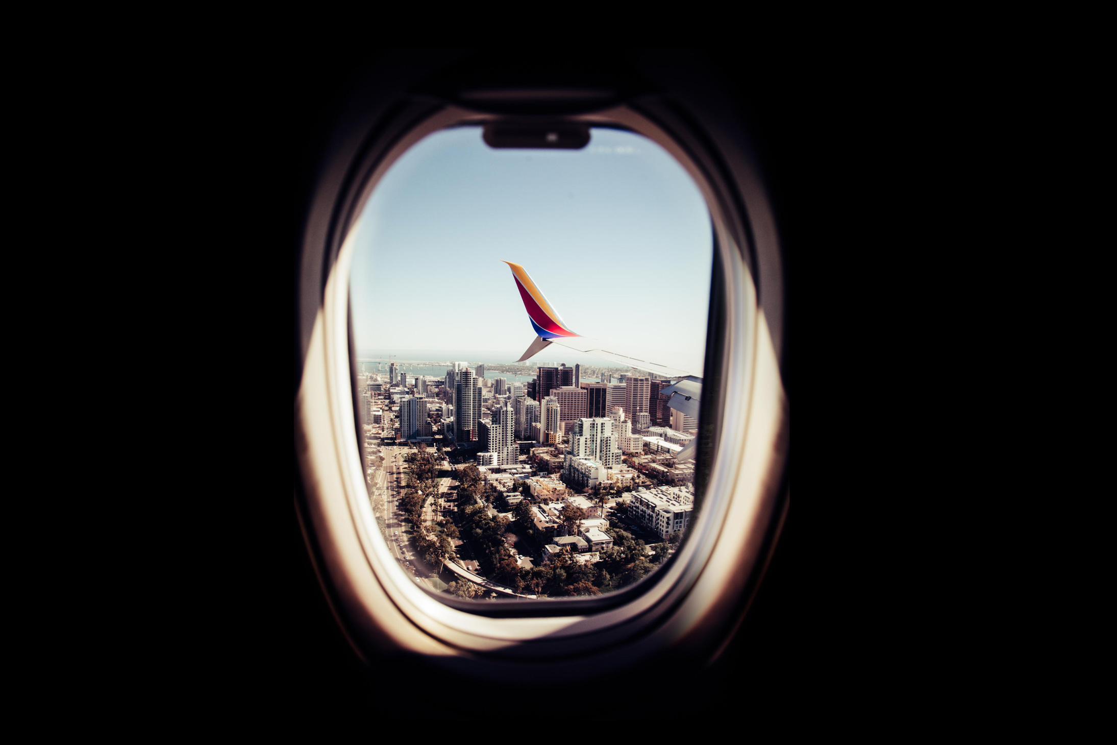 This is an image of a Southwest flight from the passengers view looking out into a city.